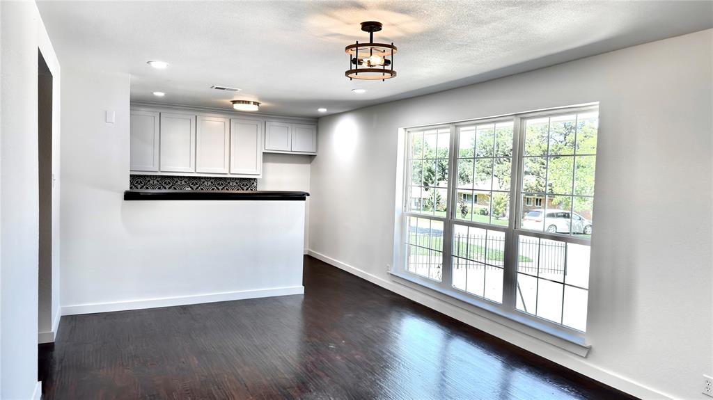 3315 Cedarcroft Lane Dallas, TX 75233 - Photo 3 of 19 a view of a kitchen with wooden floor and electronic appliances