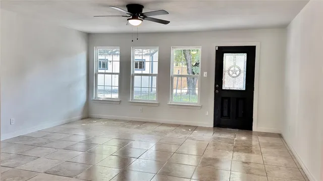 a living room with wooden floor and a chandelier