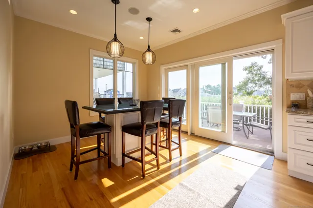 a dining room with furniture a chandelier and wooden floor