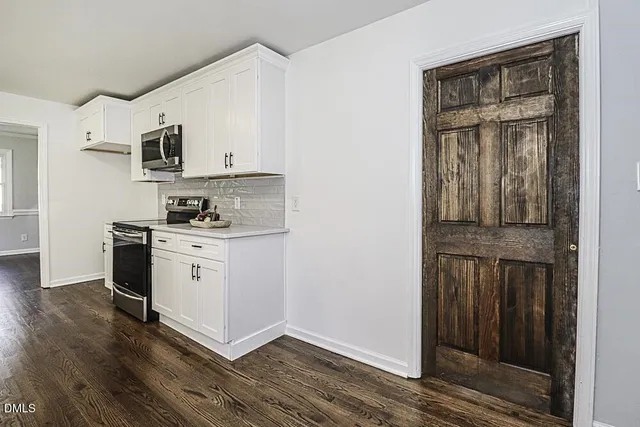 a kitchen with stainless steel appliances granite countertop a stove and a refrigerator