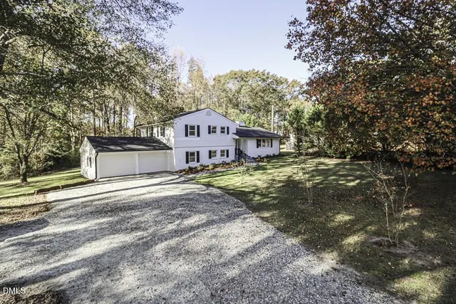 a house that has a tree in front of it