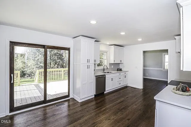 a kitchen with a white stove top oven and white cabinets