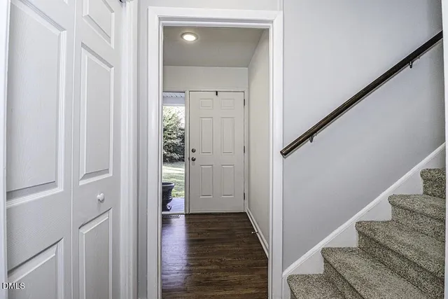 a view of a hallway with wooden floor and entryway