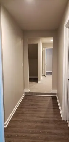 a view of a room with wooden floor