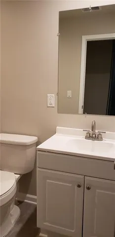 a bathroom with a sink a toilet and mirror