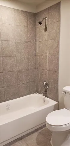 a bathroom with a toilet and a bathtub