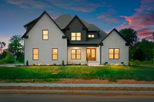a front view of a house with a yard and garage
