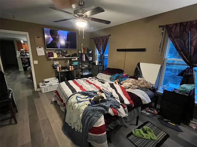 a bed room with a bed and a television