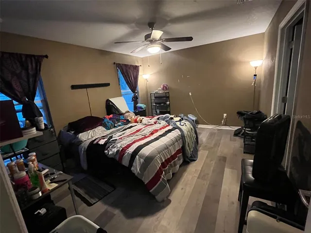 a bedroom with a bed and a mirror