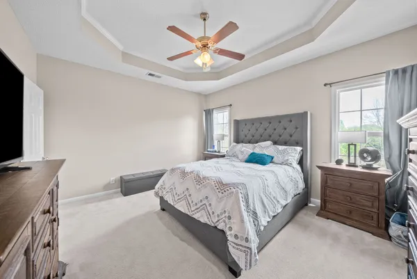 a bedroom with a large bed and a flat screen tv
