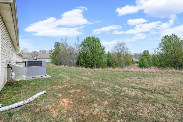 a view of a field with wooden fence
