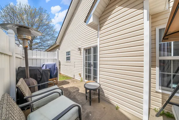 a view of a patio with a table and chairs