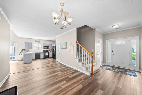 a view of a room with wooden floor and staircase