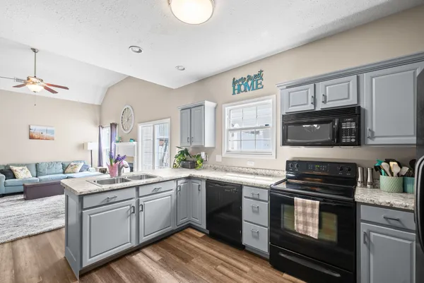 a kitchen with a sink stove and microwave