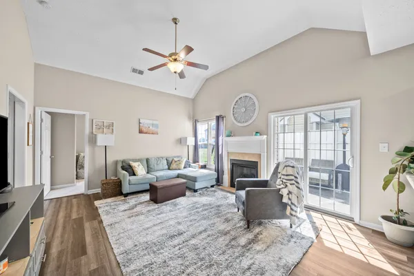a living room with furniture a fireplace and a flat screen tv