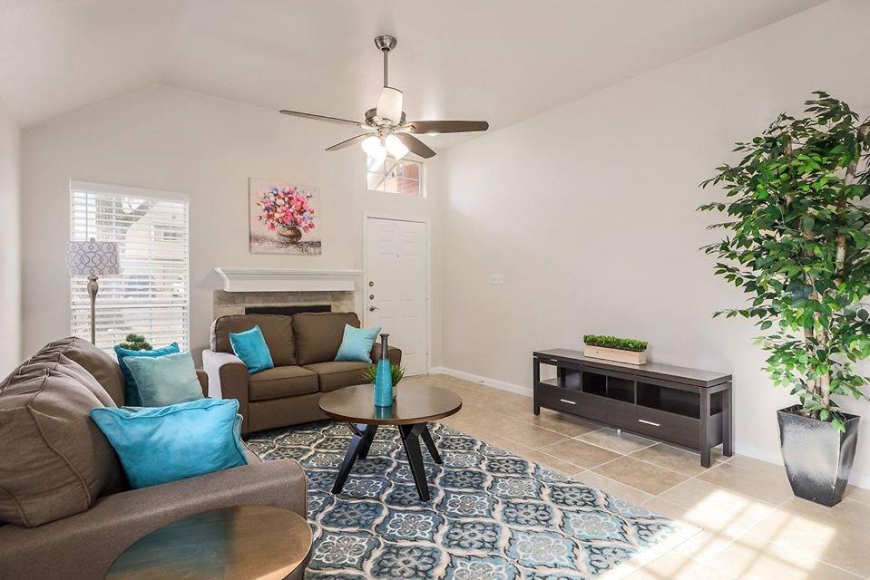 12307 Turtle Rock Road, Unit B Austin, TX 78729 - Photo 2 of 11 Tiled living room featuring lofted ceiling and ceiling fan