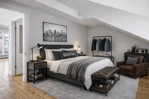 a bedroom with bed and a couch