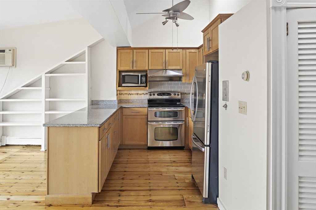 49 Worcester Street, Unit 4 Boston, MA 02118 - Photo 5 of 19 a kitchen with stainless steel appliances a refrigerator and a stove