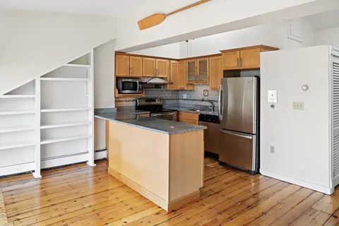 a kitchen with stainless steel appliances a refrigerator stove and microwave