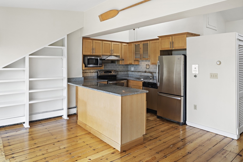 49 Worcester Street, Unit 4 Boston, MA 02118 - Photo 6 of 19 a kitchen with stainless steel appliances a refrigerator stove and microwave