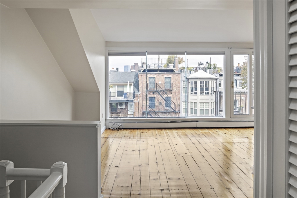 49 Worcester Street, Unit 4 Boston, MA 02118 - Photo 9 of 19 a view of empty room with wooden floor and fan