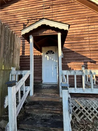 a front view of a house with stairs