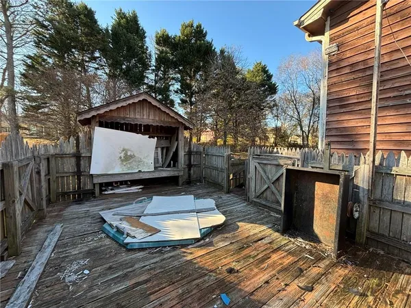 a view of a chairs and table in the backyard