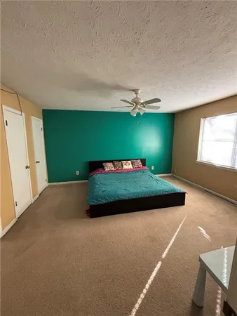 a bedroom with a bed and window