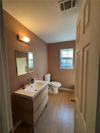 a bathroom with a toilet sink and mirror