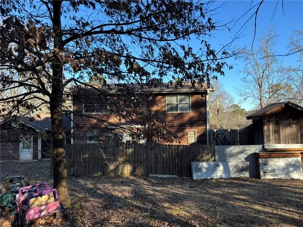 a view of a street with large trees