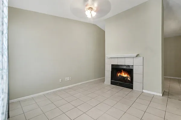 a view of an empty room with fire place