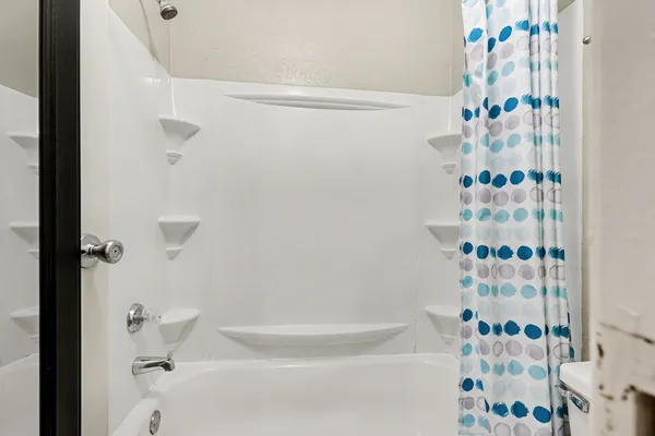 a bathroom with a bathtub and shower