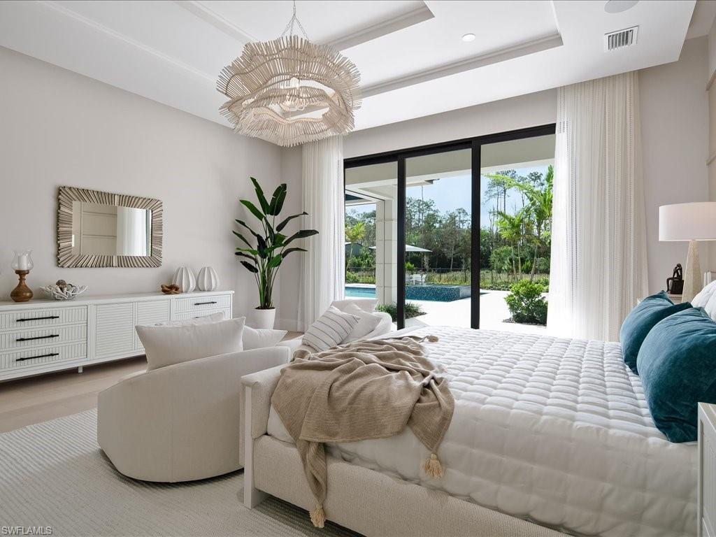 6730 Sable Ridge Lane Naples, FL 34109 - Photo 16 of 50 a bedroom with bed and large windows