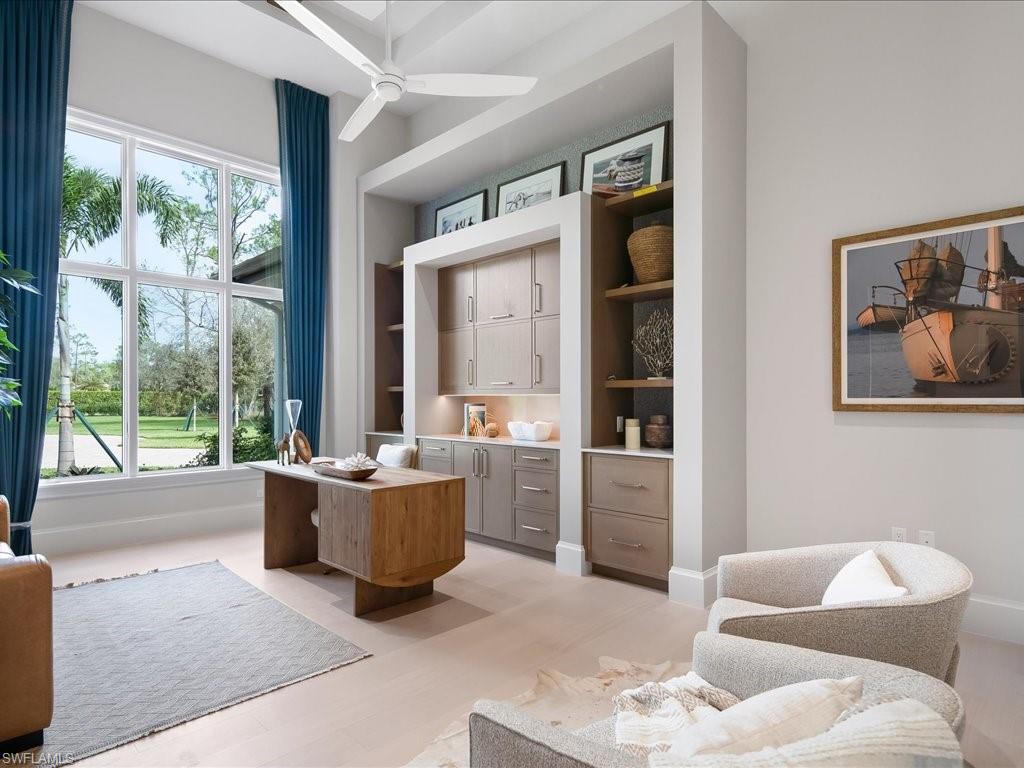 6730 Sable Ridge Lane Naples, FL 34109 - Photo 19 of 50 a living room with furniture and a large window