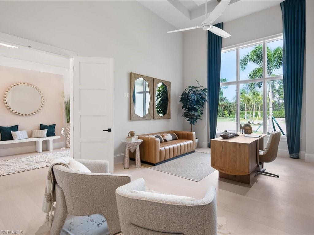 6730 Sable Ridge Lane Naples, FL 34109 - Photo 20 of 50 a living room with furniture and a large window