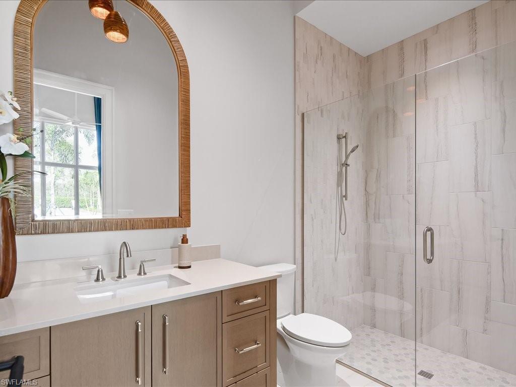 6730 Sable Ridge Lane Naples, FL 34109 - Photo 21 of 50 a bathroom with a sink a toilet and shower