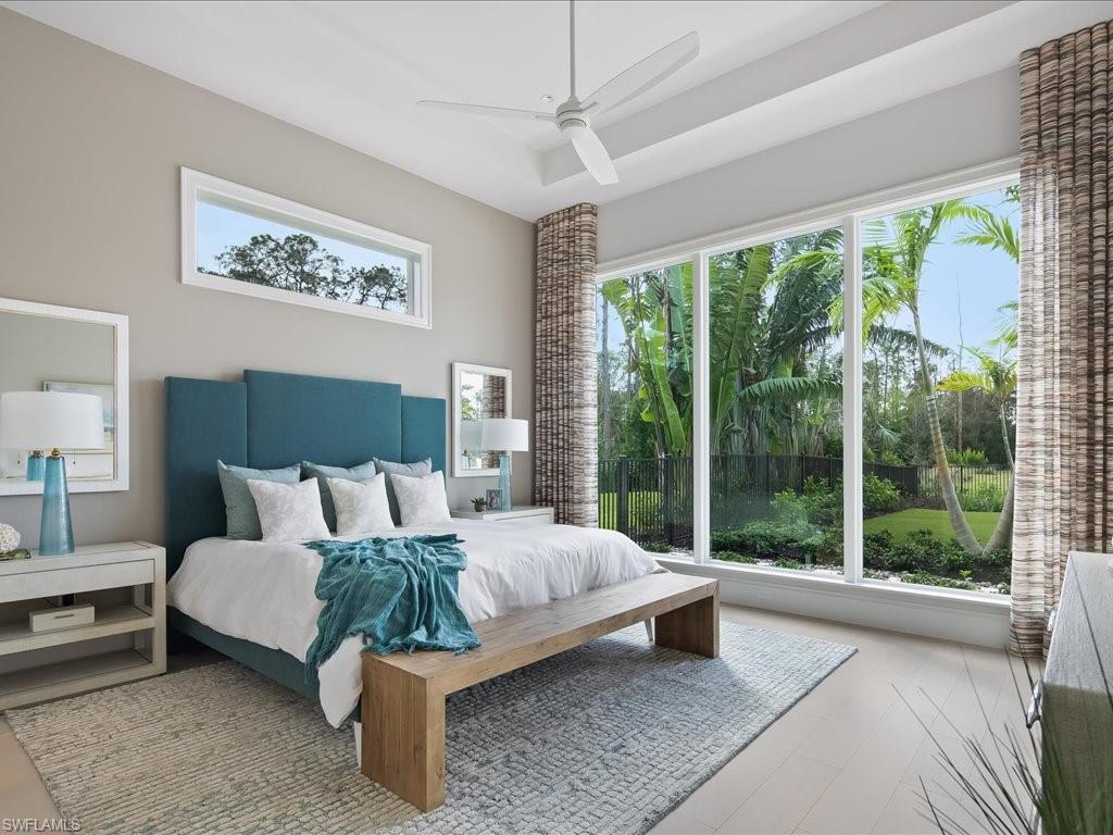 6730 Sable Ridge Lane Naples, FL 34109 - Photo 22 of 50 a bedroom with furniture and a large window
