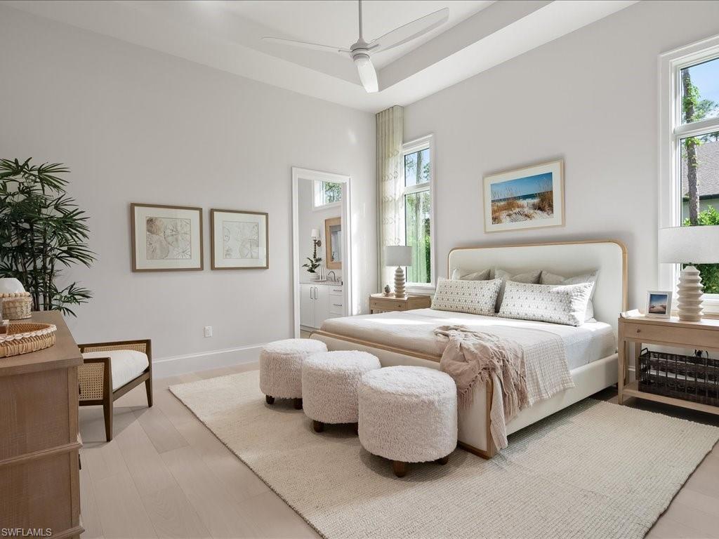 6730 Sable Ridge Lane Naples, FL 34109 - Photo 28 of 50 a bedroom with bed and a potted plant