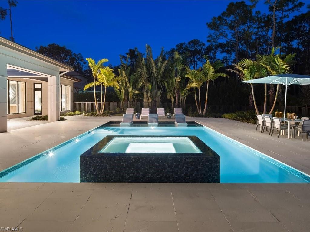 6730 Sable Ridge Lane Naples, FL 34109 - Photo 38 of 50 a swimming pool with outdoor seating and yard