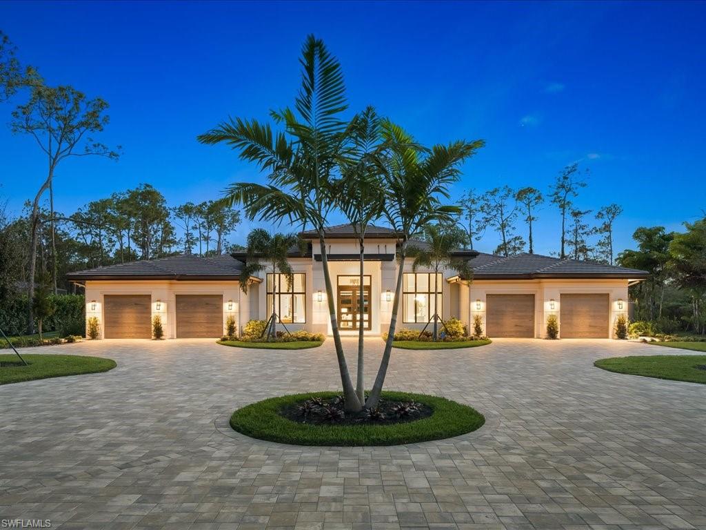 6730 Sable Ridge Lane Naples, FL 34109 - Photo 41 of 50 a front view of a house with garden