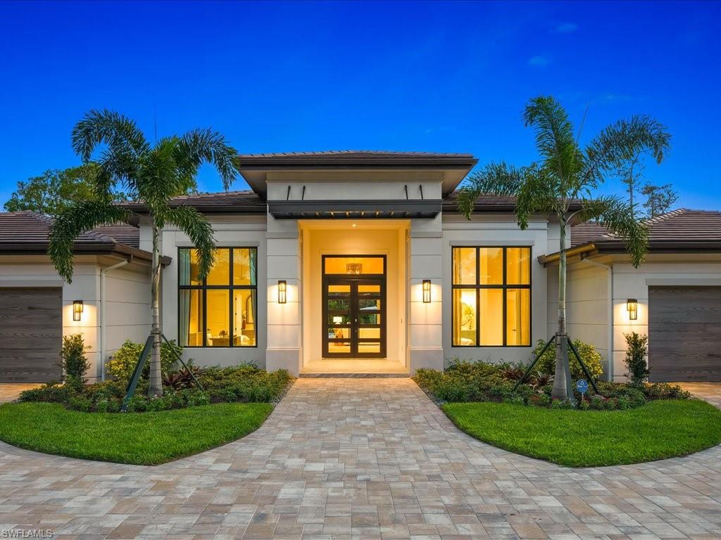 6730 Sable Ridge Lane Naples, FL 34109 - Photo 42 of 50 a front view of a house with garden
