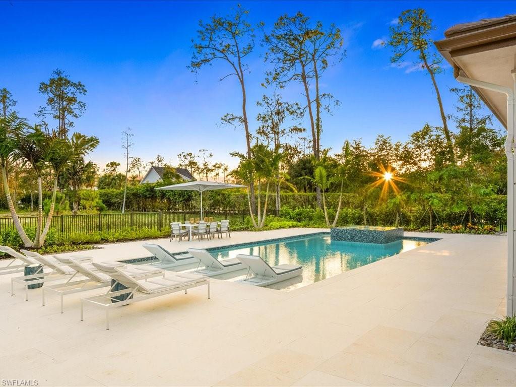 6730 Sable Ridge Lane Naples, FL 34109 - Photo 44 of 50 a view of a swimming pool with a patio