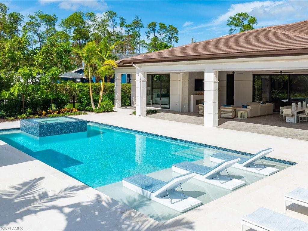 6730 Sable Ridge Lane Naples, FL 34109 - Photo 47 of 50 a view of a house with sitting area and yard with furniture