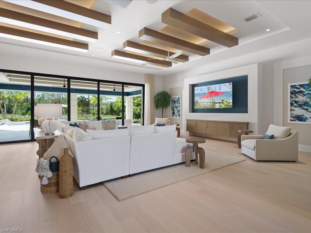 6730 Sable Ridge Lane Naples, FL 34109 - Photo 7 of 50 a living room with furniture and large windows