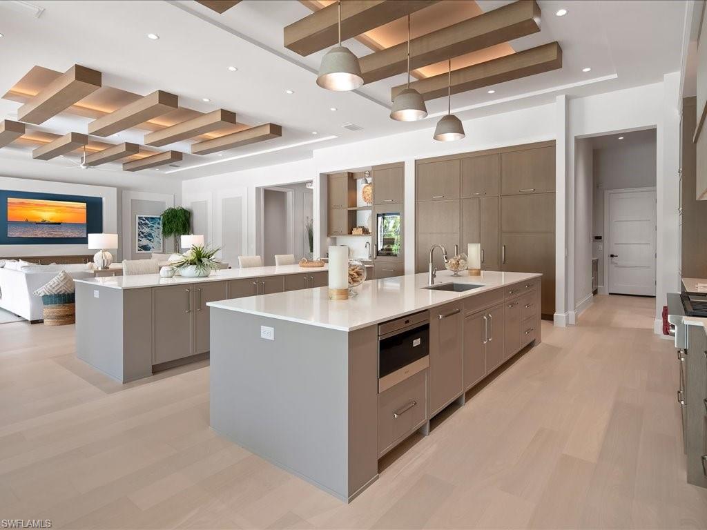 6730 Sable Ridge Lane Naples, FL 34109 - Photo 9 of 50 a kitchen with stainless steel appliances a sink and cabinets