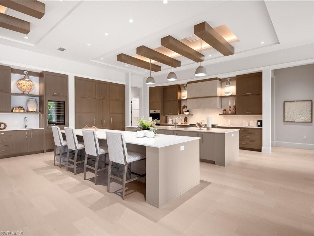 6730 Sable Ridge Lane Naples, FL 34109 - Photo 10 of 50 a large kitchen with a counter space a sink stainless steel appliances and cabinets