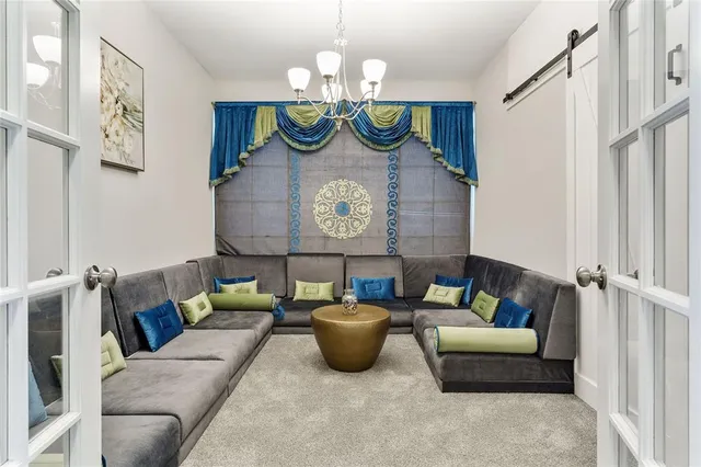 a living room with furniture and a wall