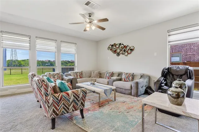 a living room with furniture stairs and a chandelier