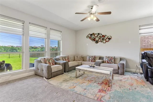 a kitchen with kitchen island granite countertop a table chairs sink and cabinets