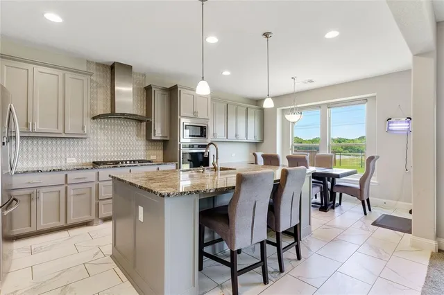a large kitchen with granite countertop a large window and a counter space